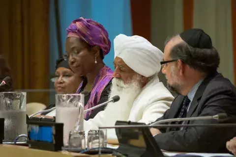 Photo by Michael Palma Mir Four religious leaders sit together at table