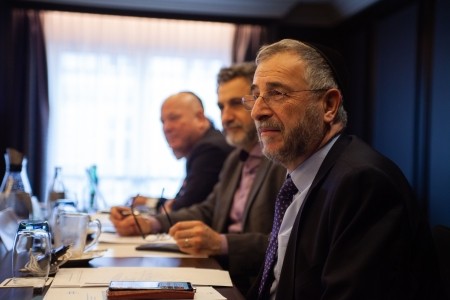 Jewish and Muslim leaders sit next to each other at a KAICIID event 