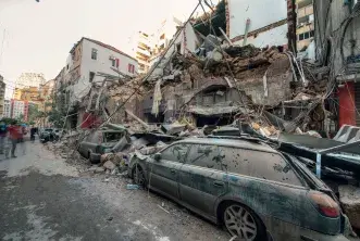 Debris from collapsed houses has fallen on a smashed car during the Beirut explosion